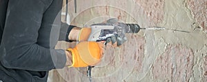 Caucasian worker using electric drill