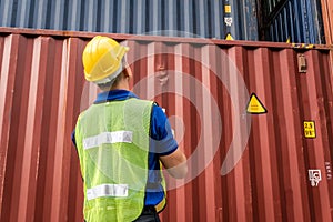 Caucasian workers wearing helmets, wearing reflective vests, holding tablets. Checking the system