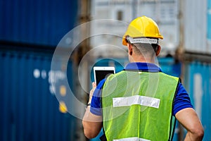 Caucasian workers wearing helmets, wearing reflective vests, holding tablets. Checking the system