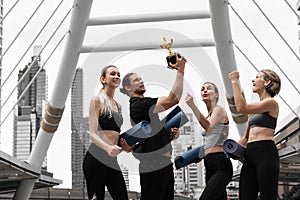 Caucasian yoga team celebration the winning trophy recieve from yoga competition championship