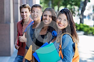 Caucasian young adult woman with group of students in line