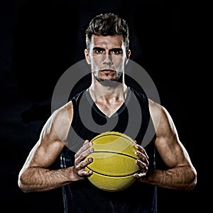 Caucasian young basketball player manisolated black background