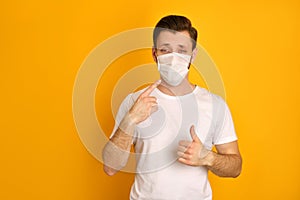 Caucasian young guy wears face mask to protect himself against covid19
