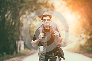 Caucasian young man backpacker travelling in local countryside