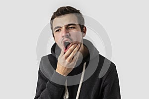 Caucasian young man having toothache. Isolated on white background. Toothache concept