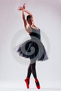 Caucasian young woman ballerina ballet dancer dancing with tutu in silhouette