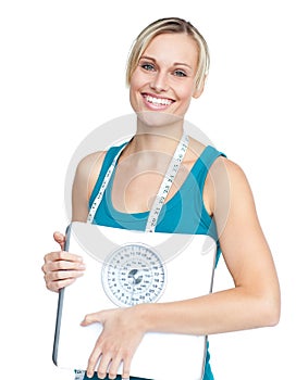 Caucasian young woman holding a weight scale