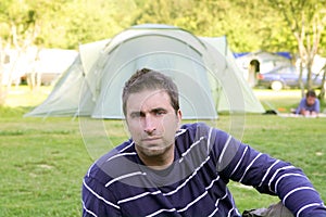 Caucassian man relaxed on camping meadow