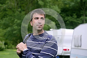 Caucassian man relaxed on camping meadow