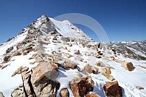 Caucasus mountains. Elbrus area. Rocks in snow.