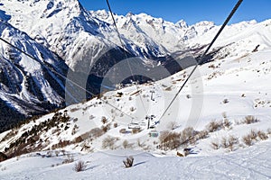 Caucasus Mountains, Panoramic view of the ski slope  on the horizon in winter day. Dombai ski resort, Western Caucasus, Karachai-