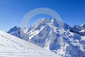 Caucasus Mountains, Panoramic view of the ski slope  on the horizon in winter day. Dombai ski resort, Western Caucasus, Karachai-