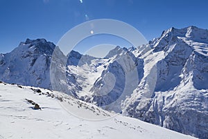 Caucasus Mountains, Panoramic view of the ski slope  on the horizon in winter day. Dombai ski resort, Western Caucasus, Karachai-