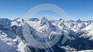 Caucasus Mountains, Panoramic view of the ski slope with the mountains Belalakaya, Sofrudzhu and Sulakhat on the horizon in winter