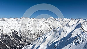 Caucasus Mountains, Panoramic view of the ski slope with the mountains Belalakaya, Sofrudzhu and Sulakhat on the horizon in winter