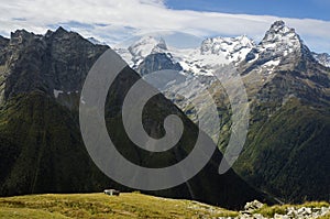 Caucasus Mountains. Small wooden cabin, shelter, on a hill.