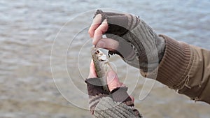 A caught a small fish by the bait, but it unexpectedly slips out of its hands.