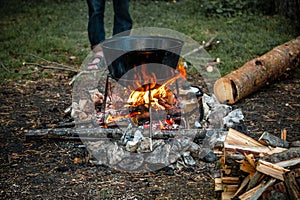 A cauldron for cooking is on the fire