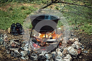 A cauldron for cooking is on the fire