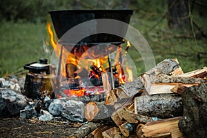 A cauldron for cooking is on the fire