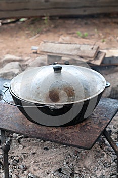 Cauldron is covered by lid for pilaff cooking. Rice pilaf cooking series, a vertical image photo