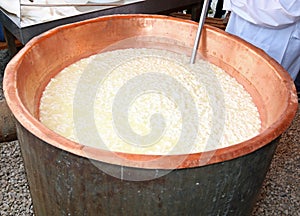 cauldron with the curdled milk to make cheese
