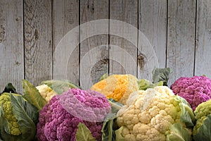 Cauliflower cabbage on wooden background with place for note