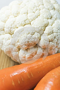 Cauliflower and carrots on a cutting board