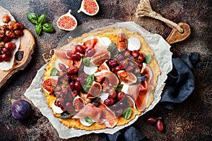 Cauliflower pizza crust with figs, prosciutto, goat cheese and red grapes. Grain free, low carb, gluten free, keto diet concept