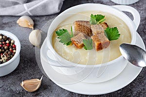 Cauliflower potato soup puree on stone background,