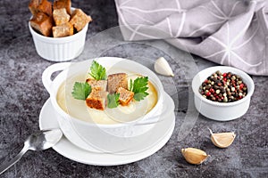 Cauliflower potato soup puree on stone background, Creamy cauliflower soup with toasted bread croutons