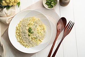 Cauliflower rice in white plate.Low carb diet, healthy eating and low calories food.