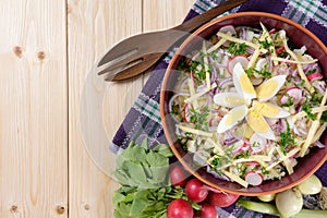 Cauliflower salad with potatoes, hard cheese, eggs, red onion and radish