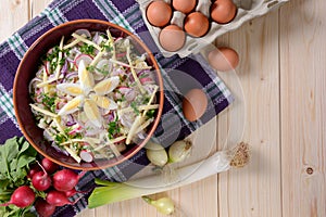 Cauliflower salad with potatoes, hard cheese, eggs, red onion and radish