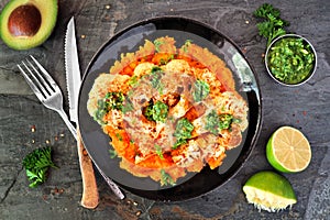 Cauliflower steak with sweet potato mash, above view scene on a dark stone background