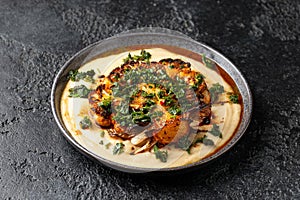 Cauliflower steaks with chimichurri sauce and butter bean puree