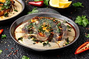 Cauliflower steaks with chimichurri sauce and butter bean puree