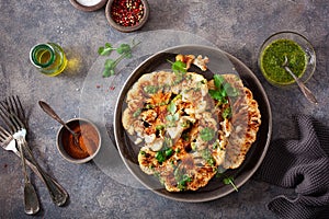 Cauliflower steaks with herb sauce and spice. plant based meat substitute