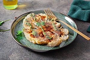 Cauliflower steaks with herb sauce and spice. plant based meat substitute