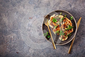 Cauliflower steaks with herb sauce and spice. plant based meat substitute