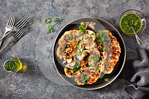 Cauliflower steaks with herb sauce and spice. plant based meat substitute photo