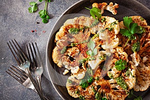 cauliflower steaks with herb sauce and spice. plant based meat substitute