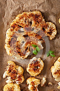 Cauliflower steaks with herb and spice on baking tray. plant based meat substitute