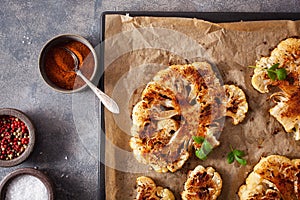 Cauliflower steaks with herb and spice on baking tray. plant based meat substitute photo