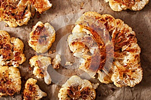 Cauliflower steaks with herb and spice on baking tray. plant based meat substitute