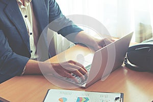 Causal worker hand typing using laptop