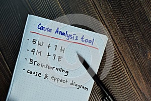 Cause Analysis Tool with keywords write on sticky notes isolated on Wooden Table