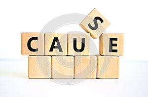 Cause symbol. The concept word `cause` on wooden cubes on a beautiful white table, white background. Business and cause concept.