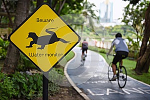 Caution beware water monitor traffic sign and bike lanes