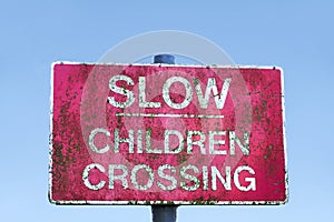 Caution children crossing road safety sign blue sky